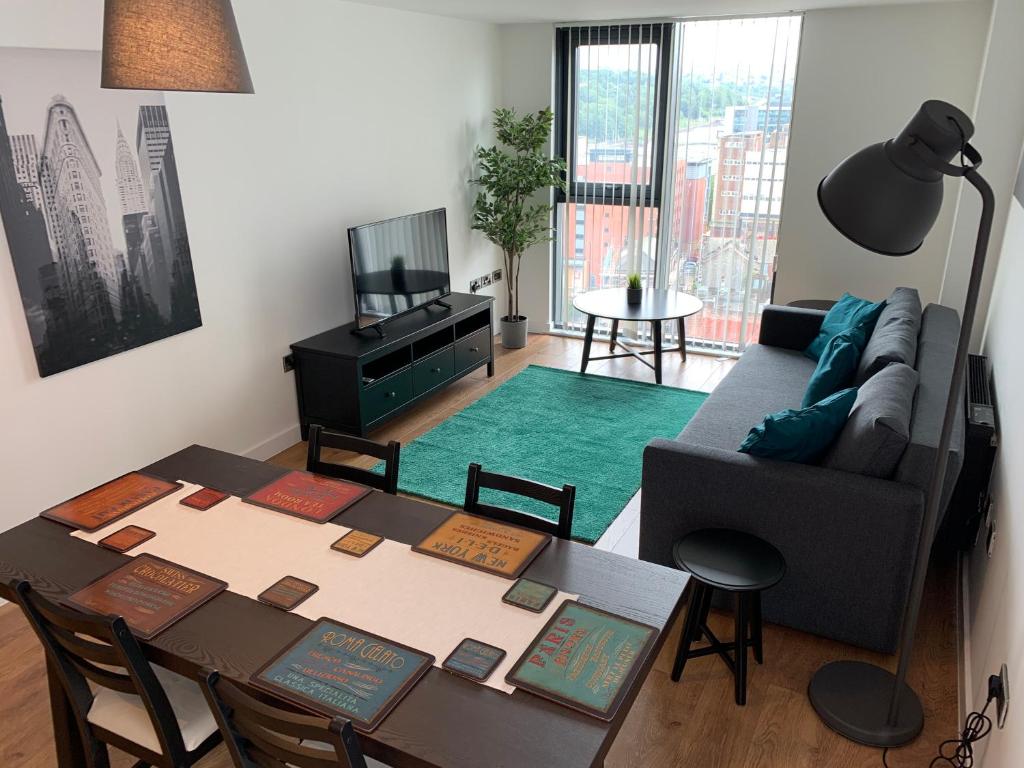 a living room with a table and a couch at Sleeps up to 6, single beds available with perfect city centre location for work or leisure, Amazing city views! in Sheffield