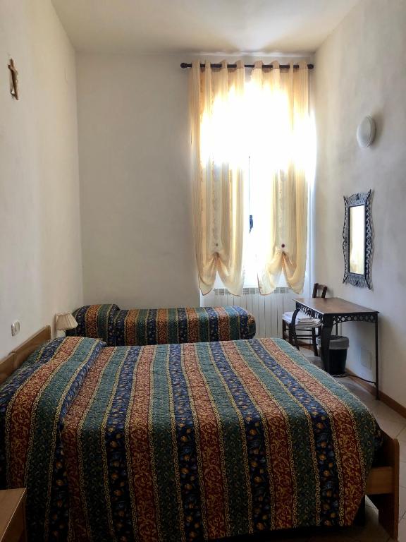 Posteľ alebo postele v izbe v ubytovaní Residenza Pitigliano Gens Petilia - Nuova gestione