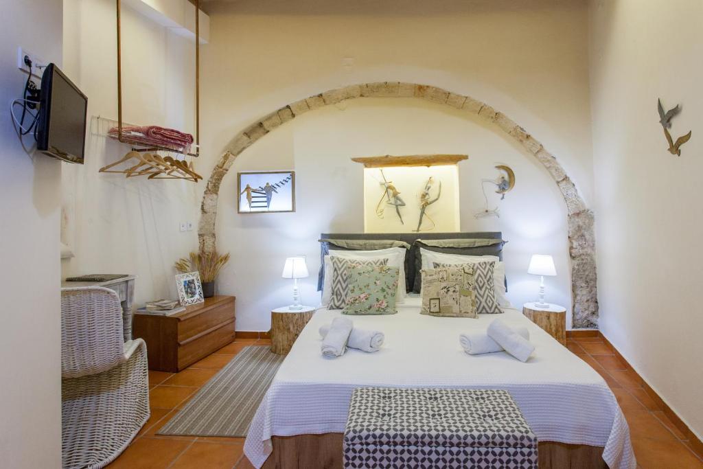 a bedroom with a bed and a tv in a room at Charming Flatlet in the Old Town in Chania