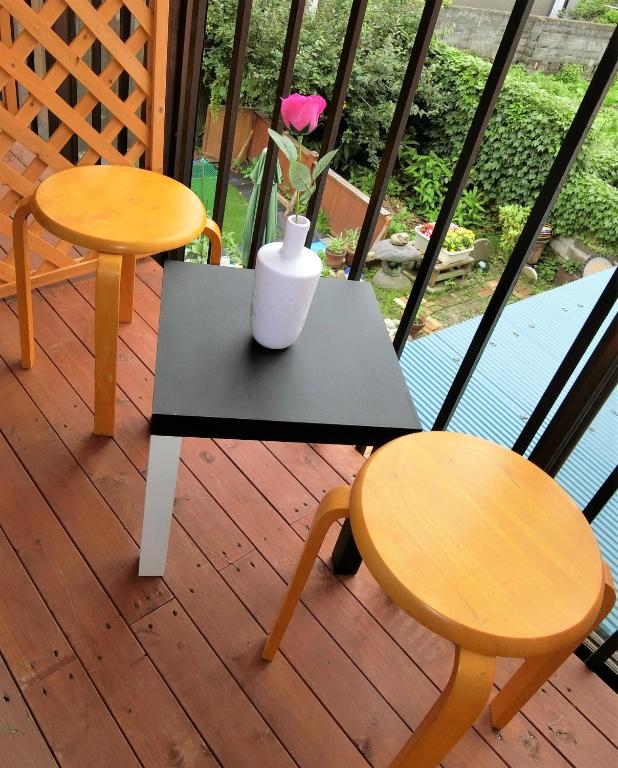 two tables and two chairs on a balcony at Shirokuma Inn in Toyama