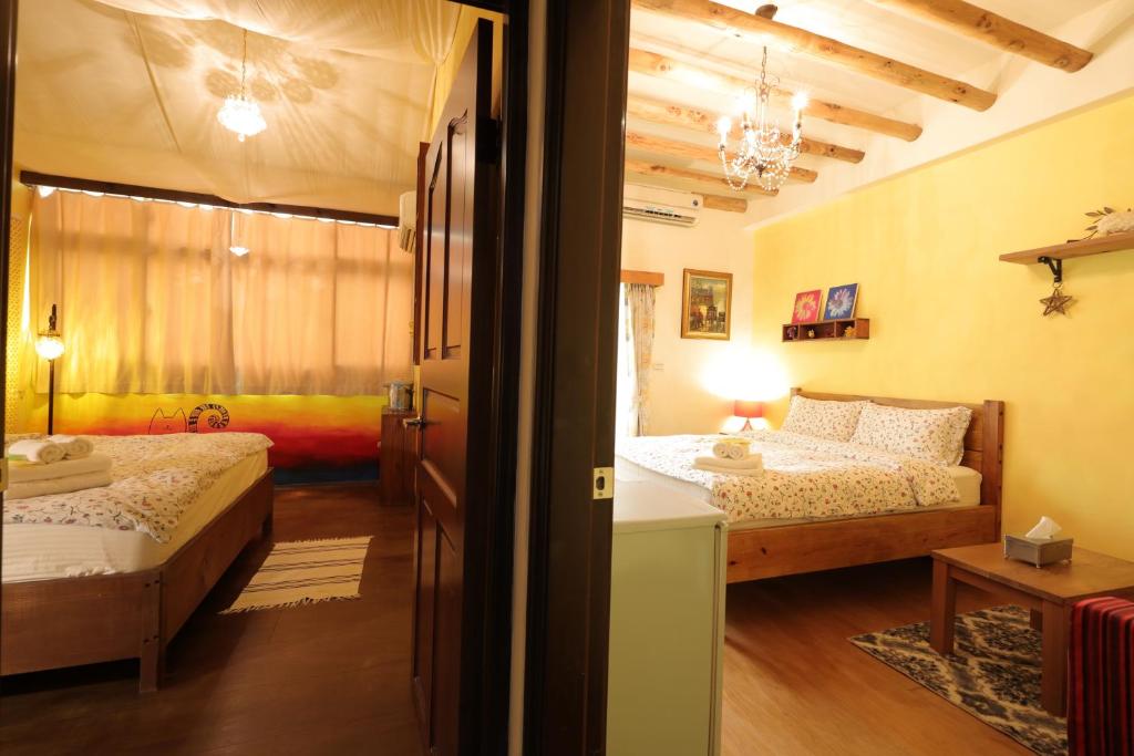 a bedroom with two beds and a window in it at Seville Countrified B&amp;B in Hualien City