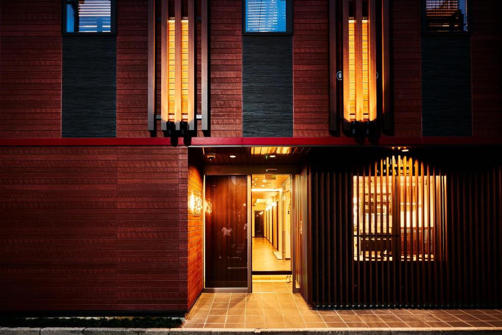 a hallway leading to a building with a door at Guest House Wagokoro in Tokyo