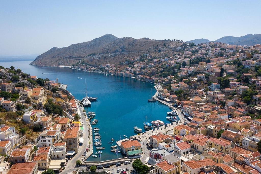 an aerial view of a city with a harbor at Grace Hotel & Studios in Symi