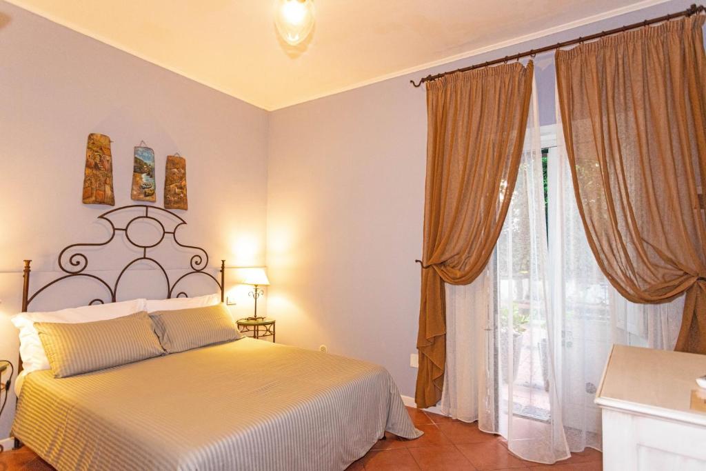 Postel nebo postele na pokoji v ubytování Etna Hotel