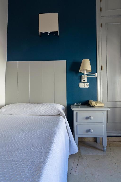 Postel nebo postele na pokoji v ubytování Hostal Drago