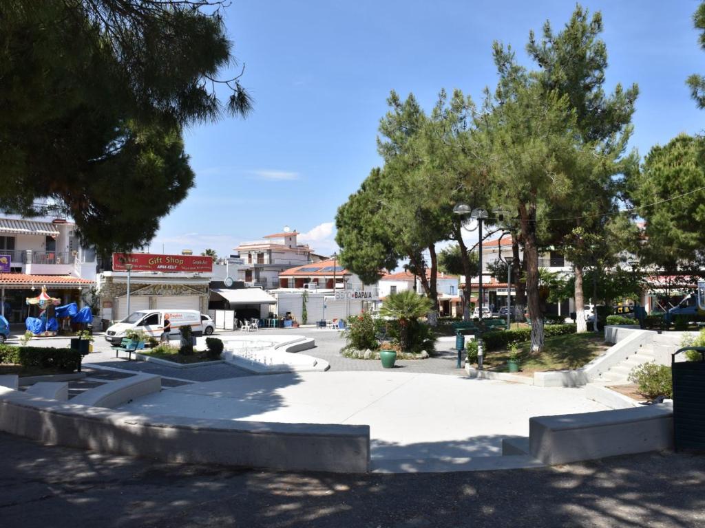 un parc dans une ville avec des arbres et des bâtiments dans l'établissement Kassandros Studios - Hanioti Halkidiki, à Chaniotis