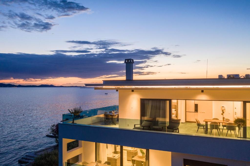 a building with a view of the water at Villa Fresca in Bibinje