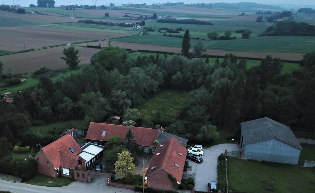 une vue aérienne sur une maison avec des voitures garées dans une allée. dans l'établissement Pantgat Hof, à Bollezeele