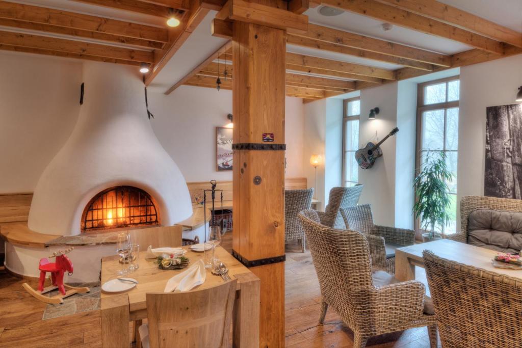 a living room with a fireplace and a table and chairs at Statek Samsara in Blansko