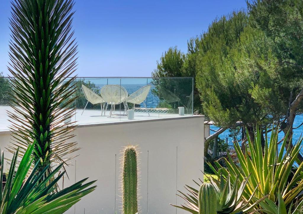 a view of the ocean from a house with trees at Villa Prado Sanary in Sanary-sur-Mer