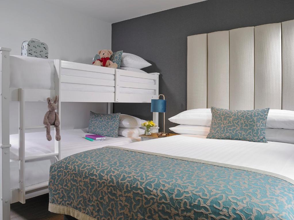 a bedroom with two bunk beds and a white bed at Asgard Apartments in Westport