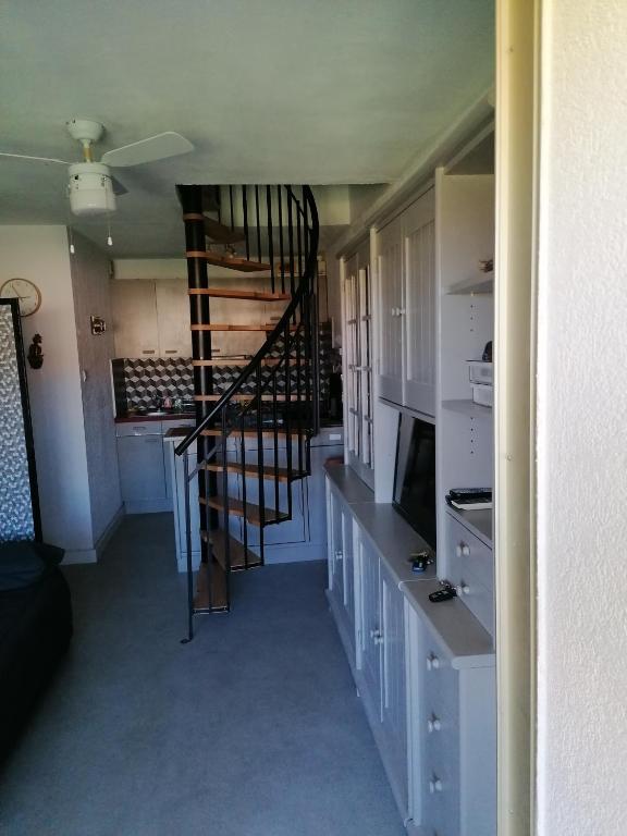 une cuisine avec un escalier en colimaçon dans une pièce dans l'établissement l'Argentiere, à La Londe-les-Maures