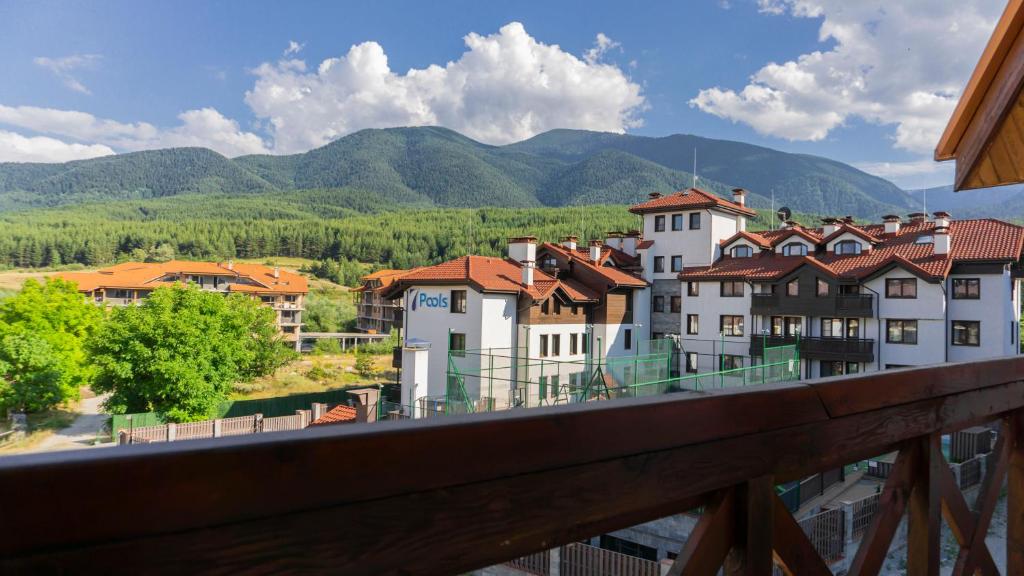 a view from a balcony of a town with mountains at Two bedroom apartments in Murphys Lodge in Bansko