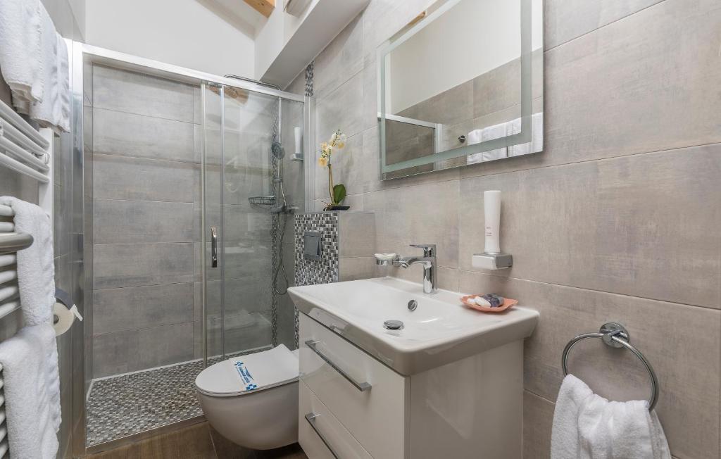 a bathroom with a toilet and a sink and a shower at Boutique Hotel Melissa in Poreč