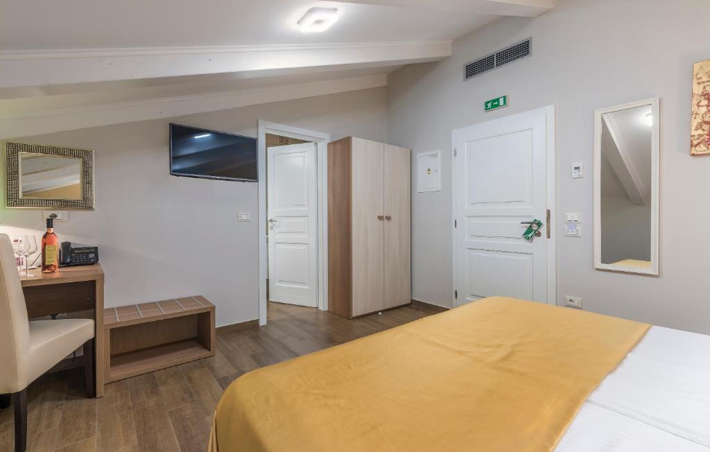 a hotel room with a bed and a desk and a desk at Boutique Hotel Melissa in Poreč