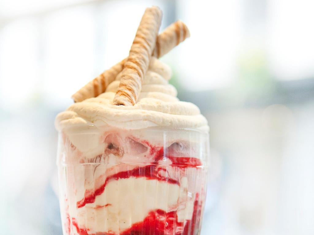 a milkshake with strawberries and whipped cream and a straw at Montcalm Brewery, London City in London