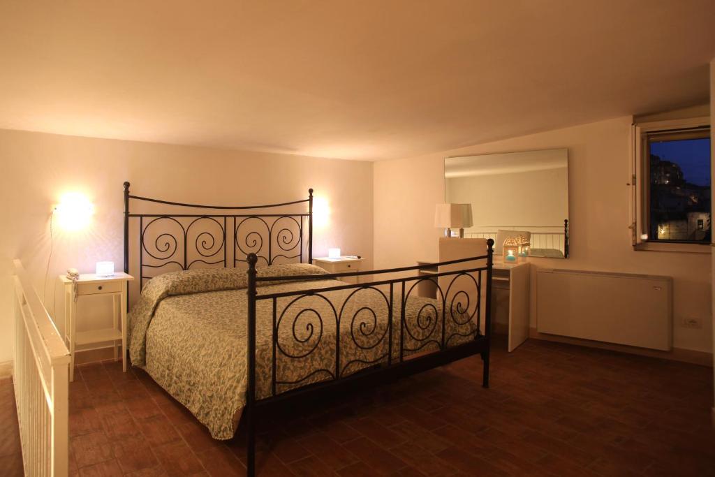Postel nebo postele na pokoji v ubytování Caveoso Hotel