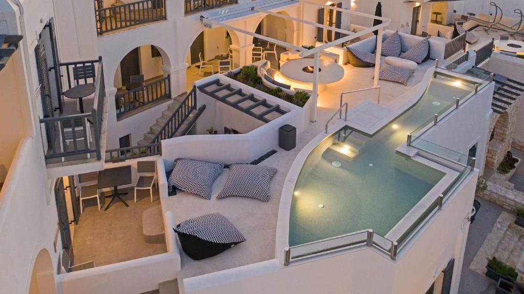 an aerial view of a building with a swimming pool at Parian Boutique Hotel in Naousa