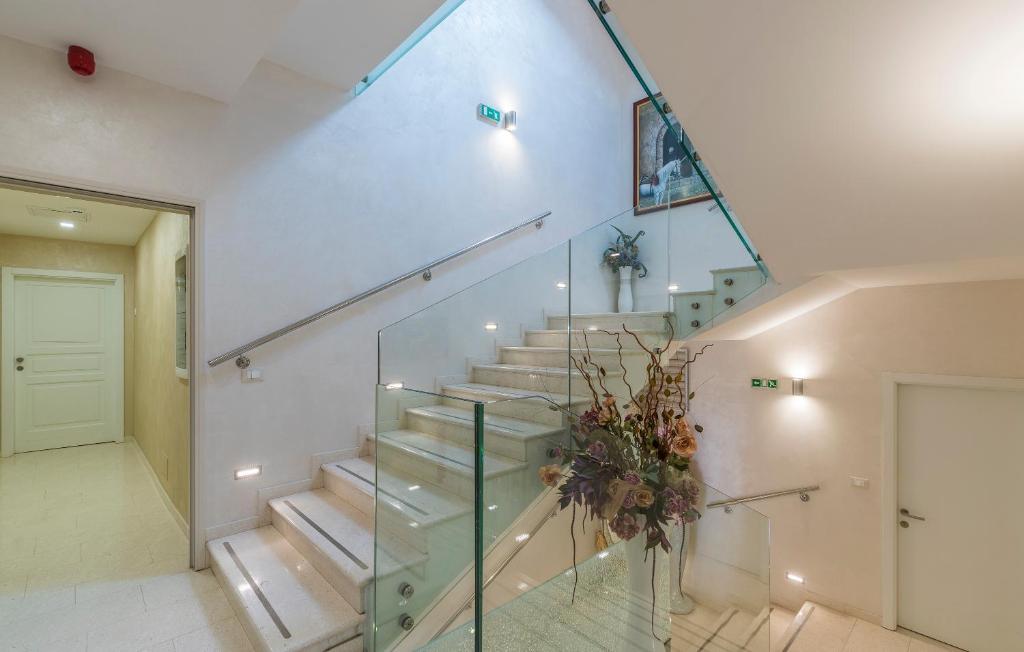 a staircase in a house with a glass railing at Boutique Hotel Melissa in Poreč