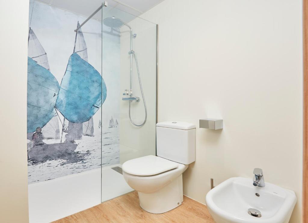 a bathroom with a toilet and a sink at Occidental Alicante in Alicante