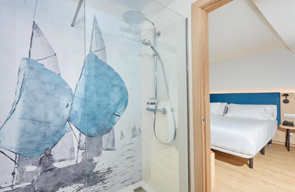 a bathroom with a shower and a bed at Occidental Alicante in Alicante
