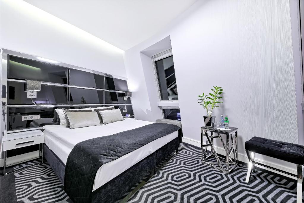 Postel nebo postele na pokoji v ubytování Bayjonn Boutique Hotel
