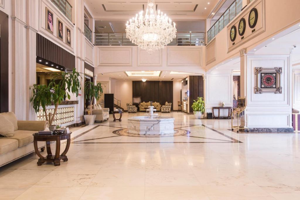 a large lobby with a chandelier in a building at Lahoya Hotel in Jeddah