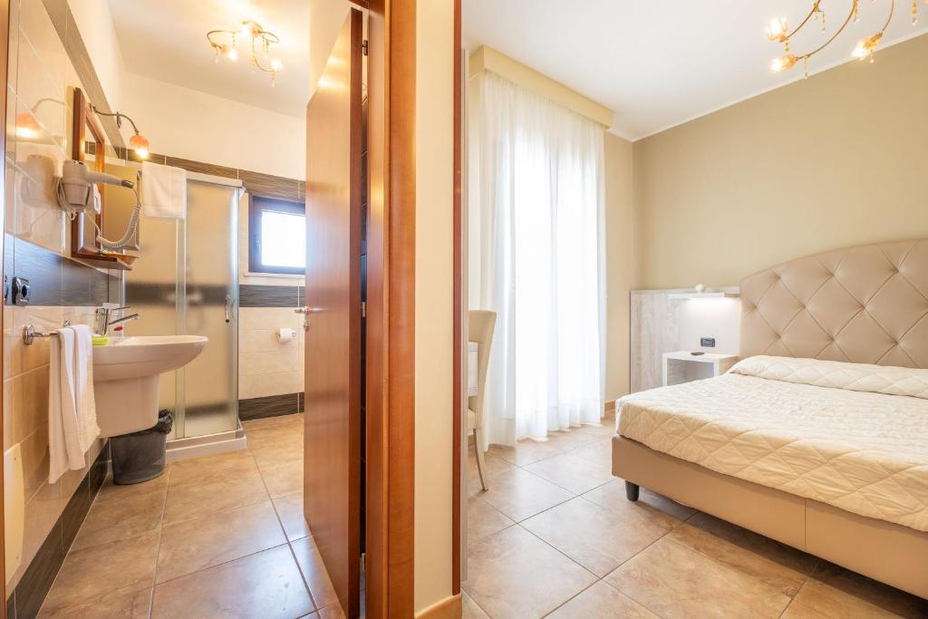 Postel nebo postele na pokoji v ubytování Hotel Salento Mirfran