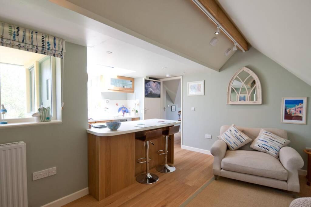a kitchen with a counter and a couch in a room at Bentley Rise in Lyme Regis
