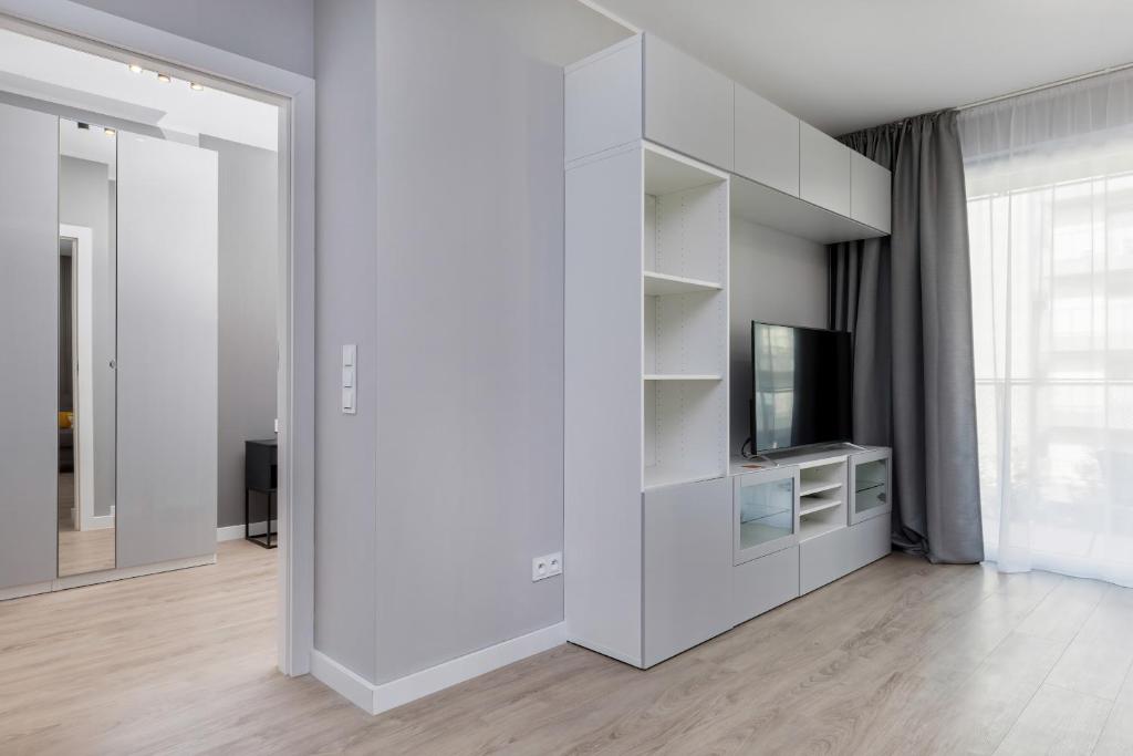 Televízia a/alebo spoločenská miestnosť v ubytovaní Modern City Center Apartments by Noclegi Renters
