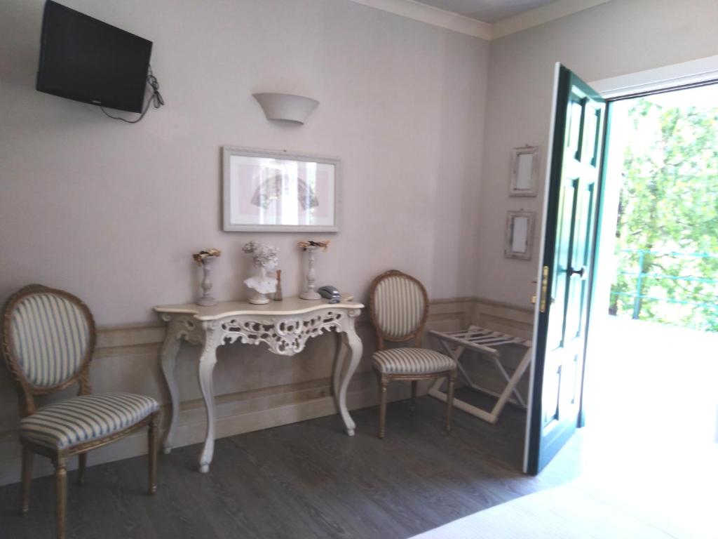 a room with a table and chairs and a television at La Cabana Cinque Terre Monterosso in Monterosso al Mare