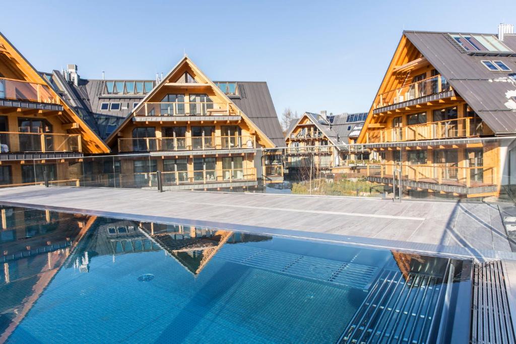 a swimming pool in front of a building at Apartamenty Royal Resort - Basen&Spa in Zakopane