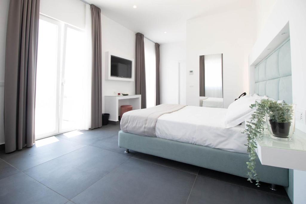 Postel nebo postele na pokoji v ubytování GRAND HOTEL SERAPIDE