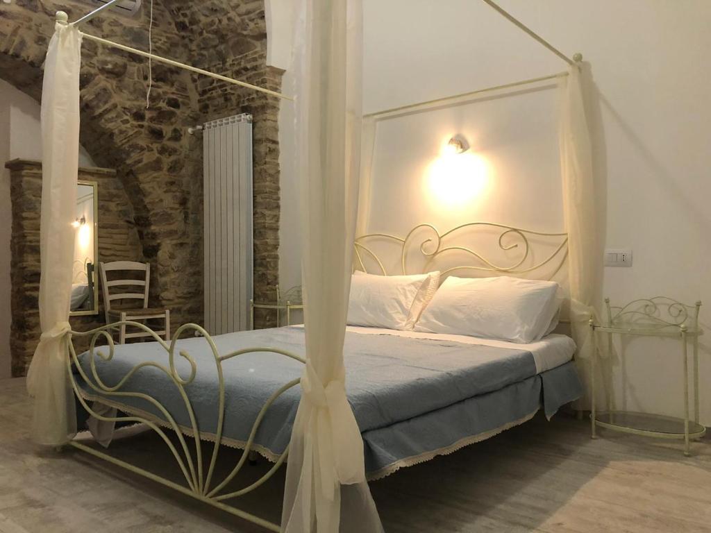 ein Schlafzimmer mit einem Himmelbett in der Unterkunft B&B Belvedere Castelluccio Valmaggiore in Castelluccio Valmaggiore