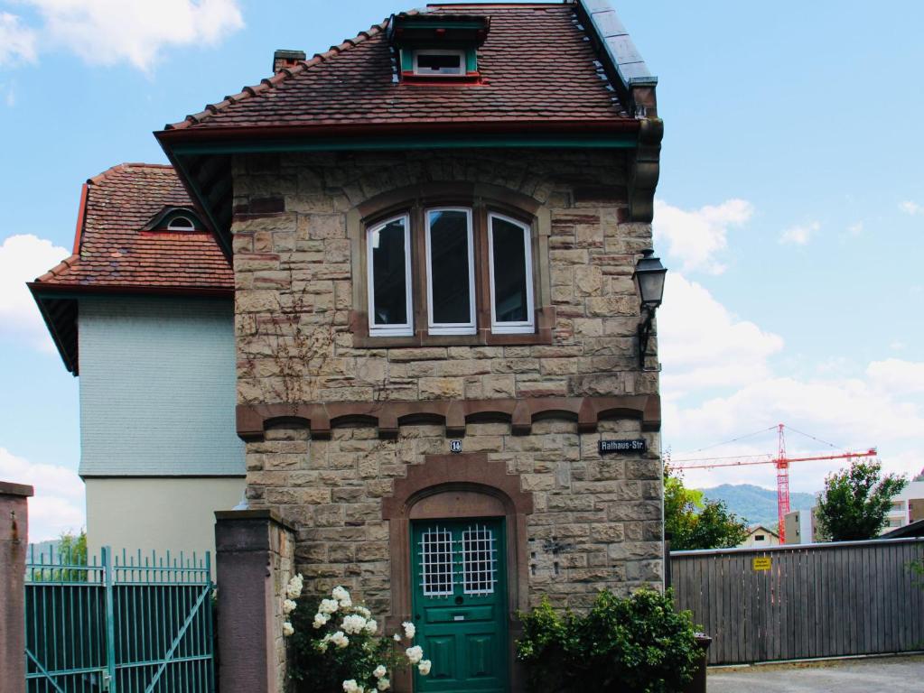 a small brick house with a green door at Altes Forstamt in Gernsbach