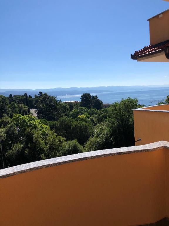 a view of the ocean from the balcony of a house at Apartments Villa Marta in Opatija