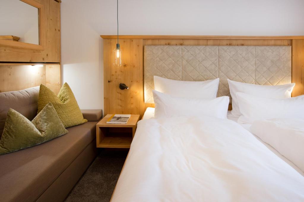 Postel nebo postele na pokoji v ubytování Boutiquehotel Hohes Licht