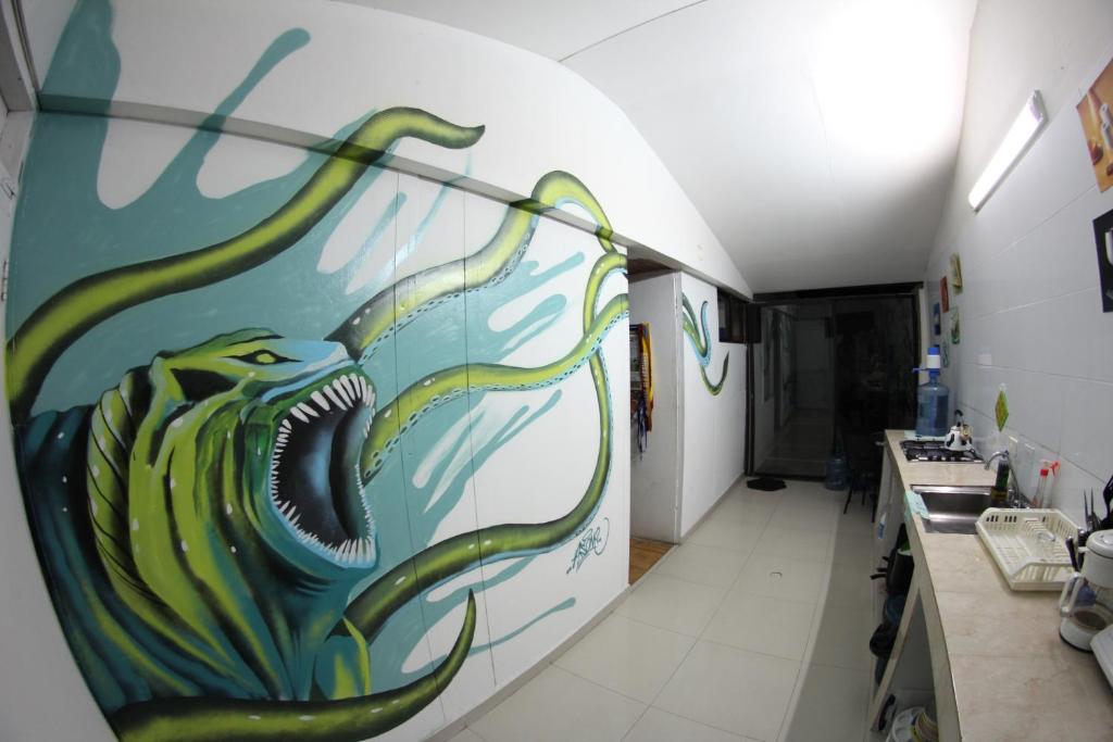 a bathroom with a painting of a fish on the wall at Blue Almond Hostel - San Andres in San Andrés