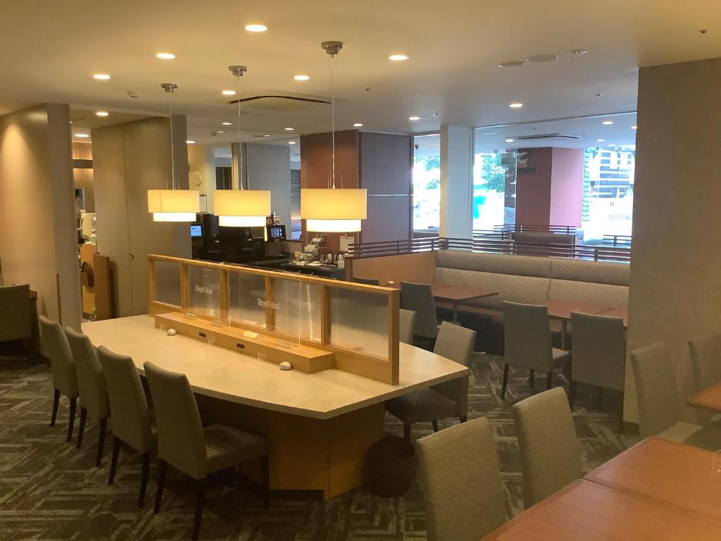 a dining room with a table and chairs at Sotetsu Fresa Inn Higashi Shinjuku in Tokyo