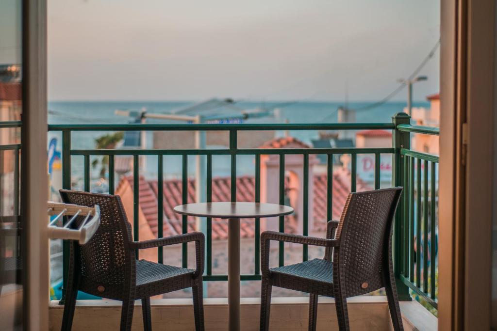 a balcony with two chairs and a table on a balcony at Stefania Studios by Estia in Stalís