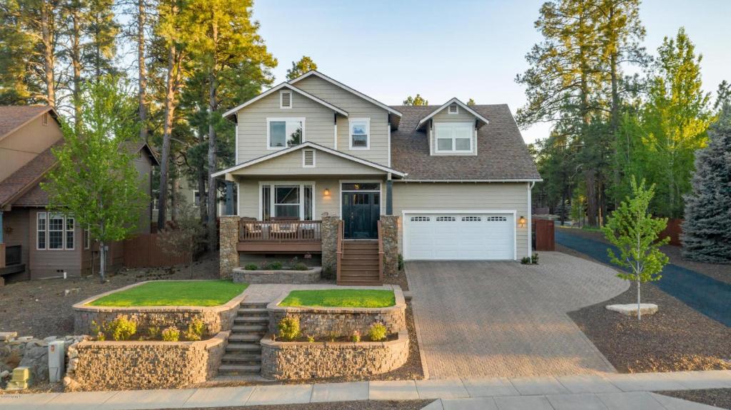 a house with a driveway and a garage at Separation Canyon Retreat in Flagstaff