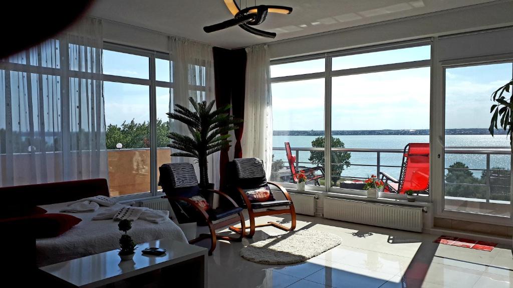 a living room with a view of the water at DreamView Mamaia SummerApt in Mamaia