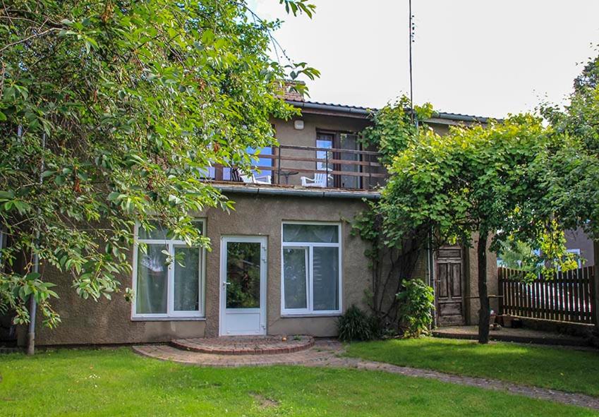 a house with a balcony on top of it at Pie Pifa in Pāvilosta