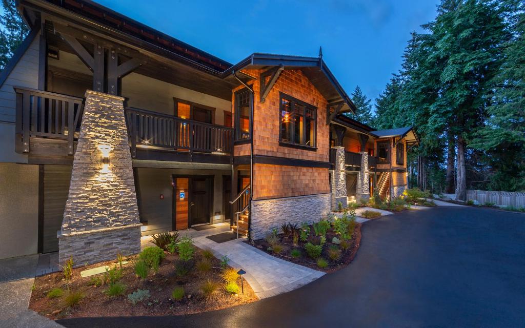 a large house with a driveway in front of it at Kingfisher Pacific Resort & Spa in Courtenay