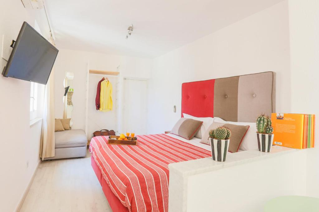 a white room with a bed and a couch at SorrentoVibes - Central Sorrento Apartment by PiazzaTasso&OldTown in Sorrento