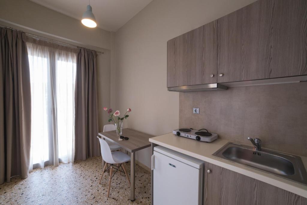 a kitchen with a sink and a table with a tableablish at Vivari Acta in Vivari