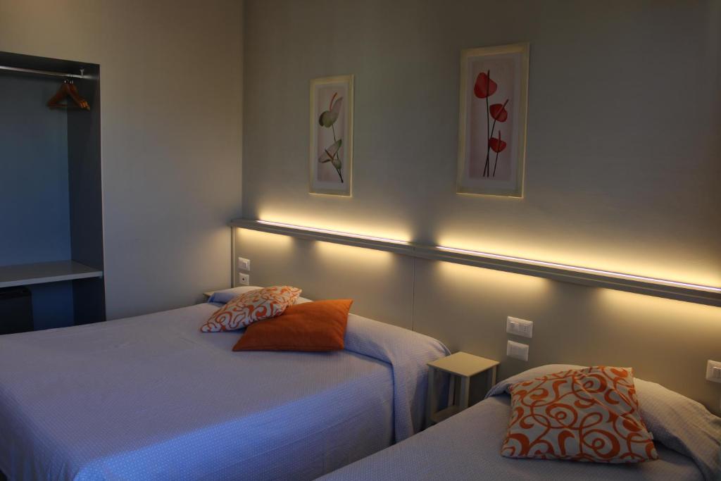 Postel nebo postele na pokoji v ubytování Hotel Delfina
