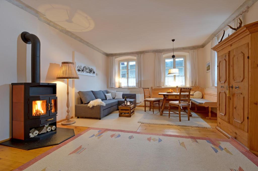a living room with a wood burning stove in it at Haus Haggenmüller in Hopfgarten im Brixental