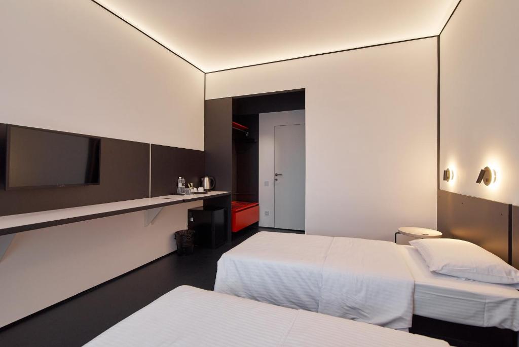 Postel nebo postele na pokoji v ubytování Atmosfera Hotel
