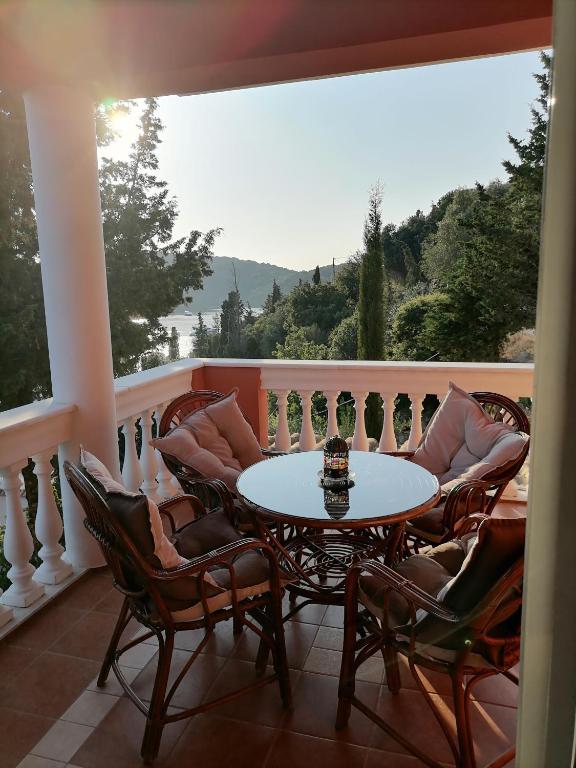 a patio with a table and chairs on a balcony at Edem Studios in Syvota